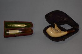 A Victorian cased meerschaum pipe, carved with a bird and having an amber mouth piece, sold together