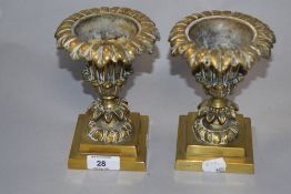 A pair of Victorian cast-brass foliate Campana-urn form vases, each resting on weighted socle 15.