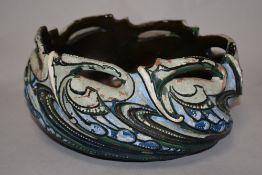 An unusual C.H Brannam, Barnstaple pottery bowl, oval form with stylised wave design, inscribed 1910