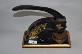 A Victorian black-painted and gilt decorated cast-iron office punch