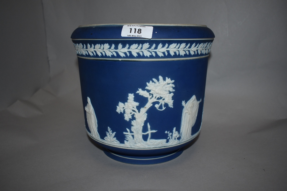 An Adams blue Jasper ware jardiniere, sprigged with classical figures within a landscape and below a