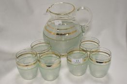 A mid century lemonade set; comprising of jug and six glasses, having green banding to lower