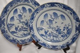 Two 19th century large Chinese chargers, having blue transfer patterns depicting traditional
