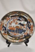 A 19th century Chinese plate, having floral decoration in blue and terracotta with gilt