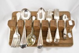 A selection of plated cutlery in vintage wooden holder.