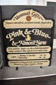 A mid 20th century hand painted shop sign advertising Pink & Blue and Almost New Unusual Gifts.