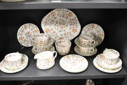A collection of Mintons 'Haddon Hall', comprising; cups, saucers, side plates, cake plate and jug.