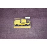 A Dinky diecast, 188 Jensen FF in yellow with black interior, on card stand under plastic case