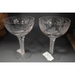 A pair of etched glass twist stem glasses.