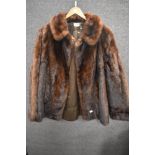 A vintage mid length ladies dark fur coat.