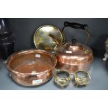 A selection of antique copper and brass wares including solid cast brass trivet, stove kettle and