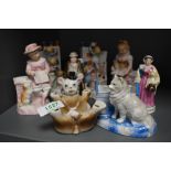 A collection of Victorian Fairings and porcelain figures including a nude piano baby.