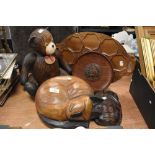 A wooden cat and teddy bear with an Indonesian style mask and a wooden snack tray.