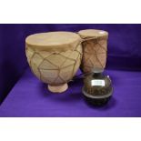 An Indian style tabla drum in terracotta an animal hide with an Indian brass bell.