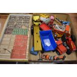 A box of vintage play worn die cast toys with a building block set.