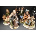 A group of five continental Capodimonte style porcelain figures, watch maker, busking tramp, young