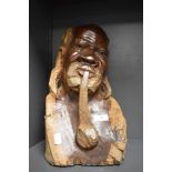A Carved wood African bust, depicting man smoking a pipe.