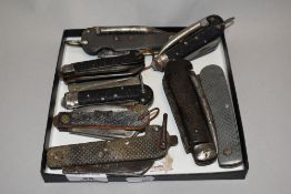 A collection of vintage pocket knives and multi tools, including guide knife.