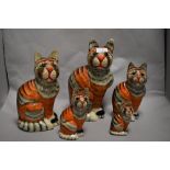 A group of five papier mache cats, having painted finish and nylon whiskers.