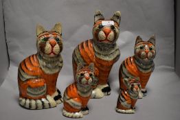 A group of five papier mache cats, having painted finish and nylon whiskers.