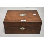 A Victorian sewing case having Rose wood case with a well fitted interior and mother of pearl