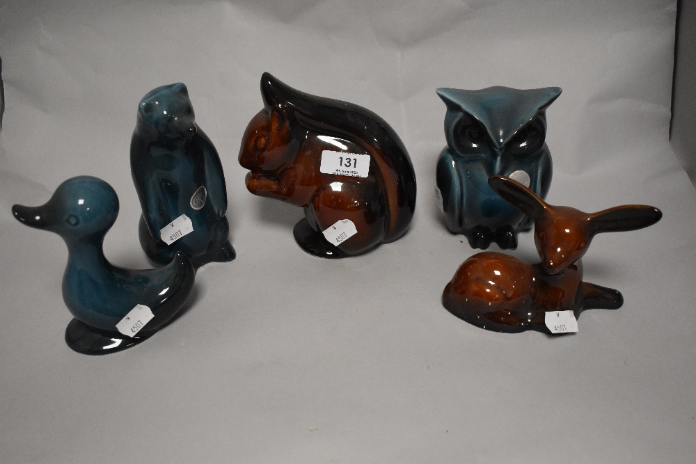 A menagerie of ceramic animals in blue and brown glazes, comprising; duck, deer, owl, squirrel and