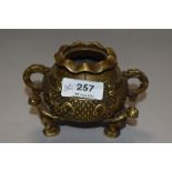 An antique Chinese cast bronze censor or Koro in the form of a lucky money pot on tripod base as