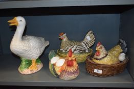 A selection of kitchen egg holders, hen and duck ornaments.