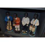 Four early to mid 20th century chalk ware musician figurines, AF.