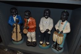 Four early to mid 20th century chalk ware musician figurines, AF.