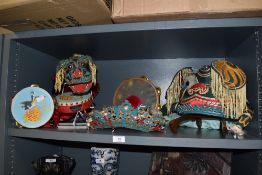 A selection of traditional Chinese headdresses and three tambourines.