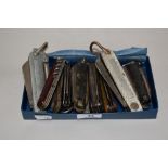 An assortment of vintage pocket knives and multi tools, including 1943 dated military issue.