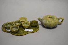 A Chinese natural green stone miniature set, to include; gourde shaped teapot, tray and six tea