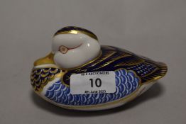 A Royal Crown Derby duck paperweight, having silver stopper.