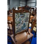 An early 20th Century mahogany framed tapestry firescreen