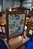 An early 20th Century mahogany framed tapestry firescreen