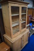 A Victorian pine kitchen cabine having glazed top with pot handle over double cupboard with brass