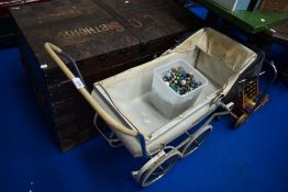 A vintage dolls pram and collection of marbles