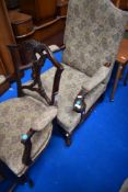 A 19th Century mahogany scroll arm chair and an early 20th Century armchair, both with similar