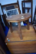 A vintage teak milking type stool