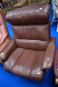 A modern Stressless recliner armchair in brown leather