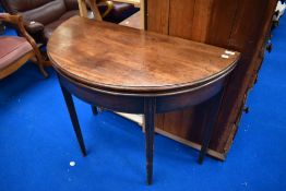 A 19th Century mahogany fold over demi lune tea table