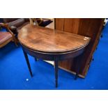 A 19th Century mahogany fold over demi lune tea table