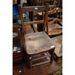 A traditional childs solid seat chair