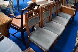 A set of four Victorian golden oak dining chairs having later upholstery