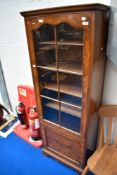 An early 20th Century walnut narrow display cabinet having cupboard below, height approx. 164cm,