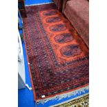A traditional persian style rug, having red shades ground