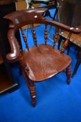 A stained frame captains style smoker bow armchair