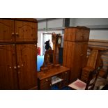 A modern pine bedroom suite comprising two wardobes, dressing table with stool, bed frame and pair