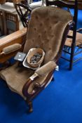 A Victorian mahogany armchair having scroll frame and later dralon upholstery